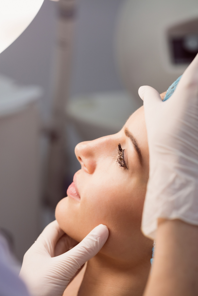 Plastic surgeon examining a patient's nasal anatomy before rhinoplasty surgery at a hospital in Kerala